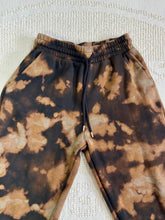 Load image into Gallery viewer, Vintage bleach-dyed sweatpants with a black and brown marbled pattern, elastic waistband, drawstring, and cuffed ankles