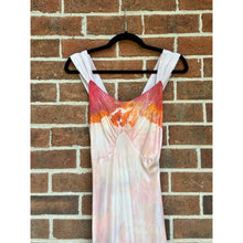 Load image into Gallery viewer, Detail of an Antique 1930s peach and rayon slip dress nightgown with lace trim and sunset-toned ice dye, hanging on a brick wall.