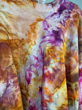 Load image into Gallery viewer, &quot;Expertly hand-dyed vintage sweatshirt featuring a one-of-a-kind ice dye pattern in vibrant shades of orange, pink, and brown. Designed with a classic crewneck, long sleeves, and ribbed cuffs. 
