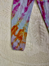 Load image into Gallery viewer, Vintage ice-dyed sweatpants featuring a mix of vibrant magenta, orange, and yellow hues against a light gray base. The pattern radiates outward, creating a bold and unique design. The pants have an elastic waistband and cuffs.
