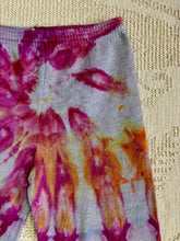 Load image into Gallery viewer, Vintage ice-dyed sweatpants featuring a mix of vibrant magenta, orange, and yellow hues against a light gray base. The pattern radiates outward, creating a bold and unique design. The pants have an elastic waistband and cuffs.
