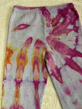 Load image into Gallery viewer, Vintage ice-dyed sweatpants featuring a mix of vibrant magenta, orange, and yellow hues against a light gray base. The pattern radiates outward, creating a bold and unique design. The pants have an elastic waistband and cuffs.
